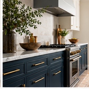 Navy base cabinets with warm brass pulls