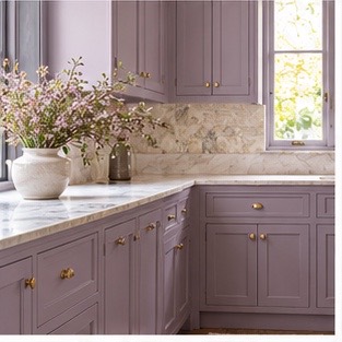 Dusty lavender cabinets with light stone counters