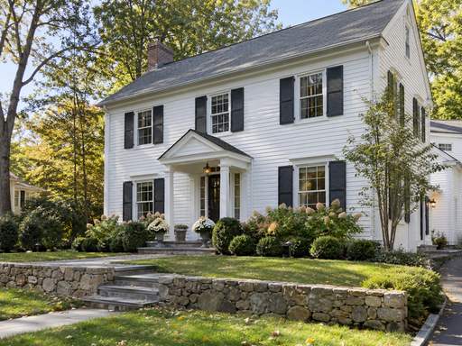 White clapboard home with charcoal shutters — Connecticut residential design inspiration