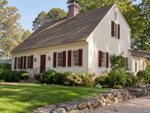 A cream clapboard Colonial with burgundy shutters — Connecticut residential design inspiration