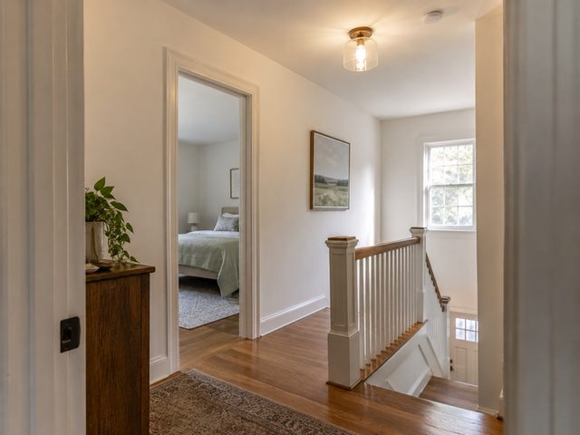 A modest upstairs foyer with fresh warm-white walls — Connecticut residential design inspiration