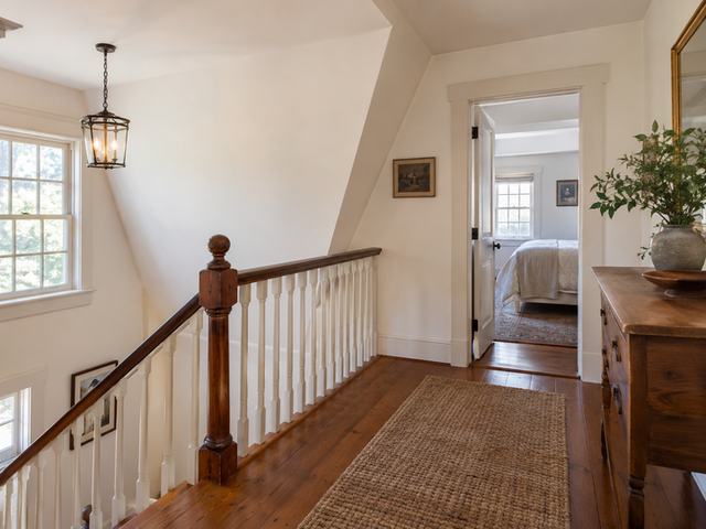 A modest upstairs foyer with fresh warm-white walls — Connecticut residential design inspiration